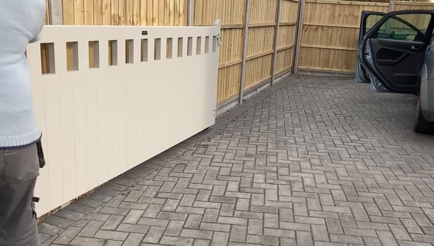 Cream painted gate beside a close-boarded fence