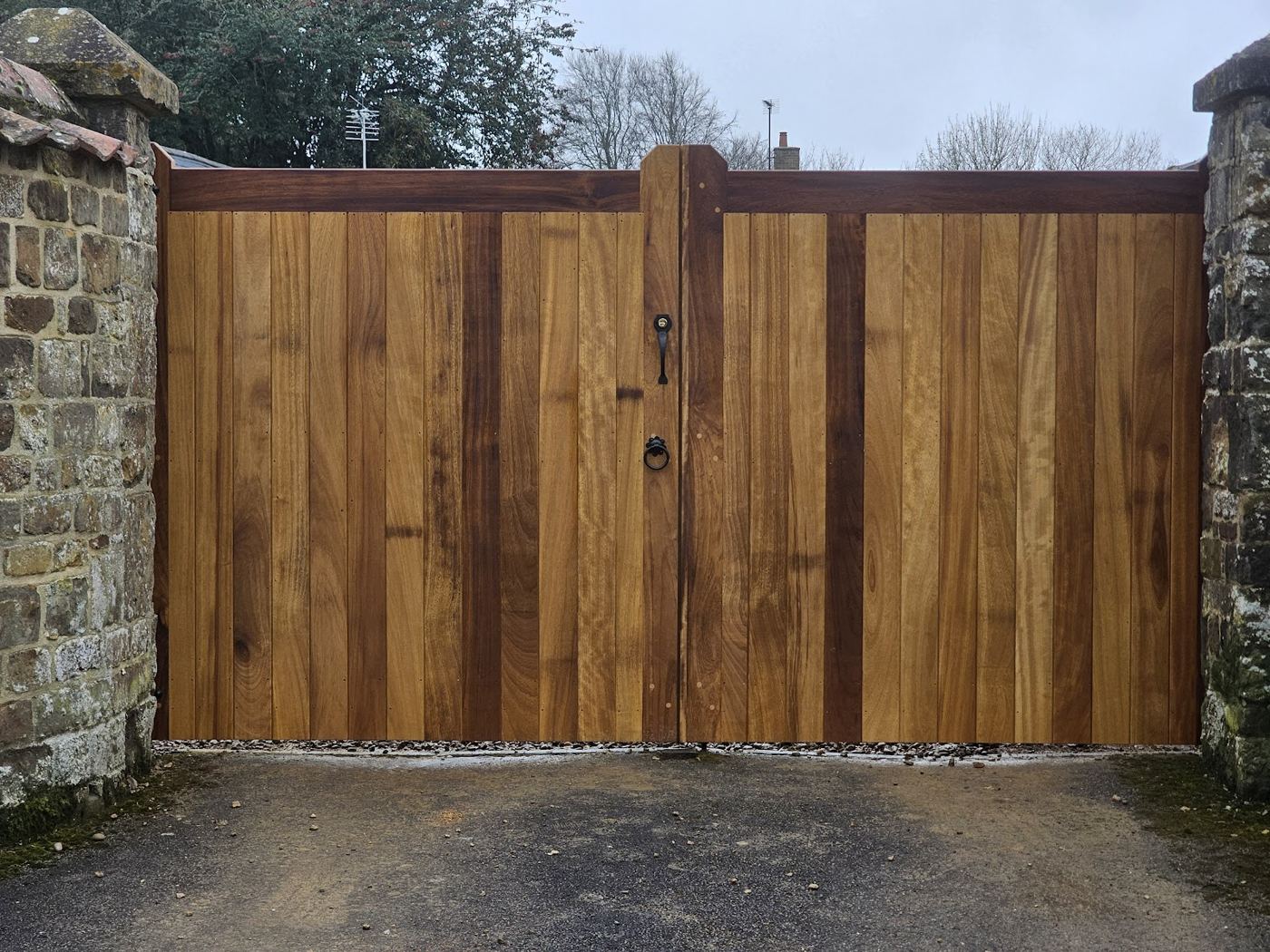 Wide boarded timber driveway gates