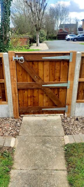 Ledged and braced gate opening onto a garden path
